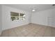 Bright, airy living room with neutral tile flooring and a ceiling fan at 306 S Highland Ave, Clearwater, FL 33755