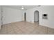 Spacious living room with neutral tile, ceiling fan, and arched entrances to other rooms at 306 S Highland Ave, Clearwater, FL 33755