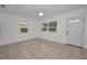 Bright living room features neutral tile floors, a ceiling fan, and a new modern door at 306 S Highland Ave, Clearwater, FL 33755