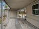 Covered patio with stone floor, structural posts, and a view of the surrounding property at 306 S Highland Ave, Clearwater, FL 33755