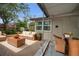 Outdoor patio with wicker furniture, an area rug, a table setting, and a partially covered structure at 306 S Highland Ave, Clearwater, FL 33755
