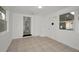 Bright sunroom with tile flooring, natural light, and an open doorway leading to other rooms at 306 S Highland Ave, Clearwater, FL 33755