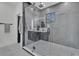Modern bathroom features a glass-enclosed shower with decorative black and white tile flooring at 3175 10Th N Ave, St Petersburg, FL 33713