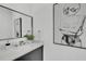 Modern bathroom featuring a sleek vanity, elegant mirror, and unique wall art at 3175 10Th N Ave, St Petersburg, FL 33713