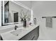 Modern bathroom featuring double sinks, sleek fixtures, and a large mirror with integrated lighting at 3175 10Th N Ave, St Petersburg, FL 33713