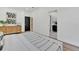 Bedroom with modern decor, ensuite bathroom, and dresser with artwork at 3175 10Th N Ave, St Petersburg, FL 33713