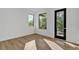 Bright, airy bedroom with hardwood floors and two large windows showcasing the outside view at 3175 10Th N Ave, St Petersburg, FL 33713