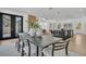 Open dining area with modern table, chairs, and decor, and large windows offer plenty of natural light at 3175 10Th N Ave, St Petersburg, FL 33713