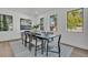 Dining area with a modern table, chairs, and decor, with natural light coming through the windows at 3175 10Th N Ave, St Petersburg, FL 33713