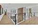 Hallway with decorative wood accent wall, modern railings, and lots of natural light at 3175 10Th N Ave, St Petersburg, FL 33713