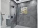 Contemporary shower features gray tiling, black fixtures, and a window with a view at 3175 10Th N Ave, St Petersburg, FL 33713