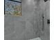 Gray tiled shower boasts a sleek design with modern fixtures and a view of nature at 3175 10Th N Ave, St Petersburg, FL 33713