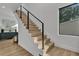 Modern staircase with wood steps, sleek metal railing, and a view of the bright interior at 3175 10Th N Ave, St Petersburg, FL 33713