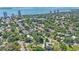 Aerial view features a home surrounded by lush greenery in a waterfront community at 3501 S Drexel Ave, Tampa, FL 33629