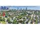 Wide aerial view of a lush neighborhood with homes and the city skyline along the bay in the background at 3501 S Drexel Ave, Tampa, FL 33629