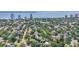 Scenic aerial view of a house nestled in a leafy neighborhood with the bay and city skyline visible at 3501 S Drexel Ave, Tampa, FL 33629