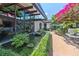 Backyard with a water feature, patio and ample shade, with plenty of lush plants and flowers at 3501 S Drexel Ave, Tampa, FL 33629