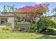 Charming backyard featuring a covered structure, lush greenery, and colorful flowering accents at 3501 S Drexel Ave, Tampa, FL 33629