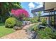 Backyard featuring lush landscaping, a water feature, a patio, and seating areas at 3501 S Drexel Ave, Tampa, FL 33629