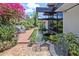 Zen-like backyard with water feature, lush garden, and outdoor seating area at 3501 S Drexel Ave, Tampa, FL 33629