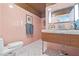 Charming bathroom features pink tiling, mosaic tile floor, and wooden vanity at 3501 S Drexel Ave, Tampa, FL 33629