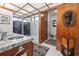 Bathroom featuring a vessel sink, wood accents, and a glass-enclosed shower with natural light and tropical plants at 3501 S Drexel Ave, Tampa, FL 33629