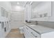 Modern bathroom features a large mirror, walk in shower, and a large, grey countertop at 3501 S Drexel Ave, Tampa, FL 33629