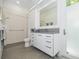 Modern bathroom features a large mirror, walk in shower, and a large, grey countertop at 3501 S Drexel Ave, Tampa, FL 33629