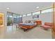 Spacious bedroom features a platform bed, sitting area, polished terrazzo flooring, and sliding door access to the outdoor space at 3501 S Drexel Ave, Tampa, FL 33629