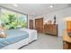 Comfortable bedroom with natural light, closet, and view of the landscaped backyard at 3501 S Drexel Ave, Tampa, FL 33629