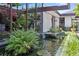 Modern home exterior with a tranquil pond and lush greenery, creating a serene and inviting ambiance at 3501 S Drexel Ave, Tampa, FL 33629