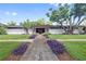 Beautiful mid-century modern home featuring lush landscaping and a symmetrical facade at 3501 S Drexel Ave, Tampa, FL 33629