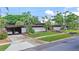 Stunning single-story home featuring a well-manicured front lawn, a long driveway, and a two-car carport at 3501 S Drexel Ave, Tampa, FL 33629