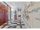 Hallway boasts a black and white checkered tile floor, artistic wall decor and door to the exterior at 3501 S Drexel Ave, Tampa, FL 33629