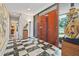 Foyer with black and white checkered tile flooring, and an ornate decorative statue at 3501 S Drexel Ave, Tampa, FL 33629