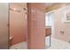 Shower features a shower seat, bright pink tiling, and a brushed metal shower head at 3501 S Drexel Ave, Tampa, FL 33629