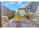 Cozy backyard featuring lawn chairs, fenced yard, and landscaping, perfect for outdoor relaxation at 3540 Cockatoo Dr, New Port Richey, FL 34652
