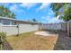Backyard area featuring fence, satellite dish, and grass lawn at 3540 Cockatoo Dr, New Port Richey, FL 34652
