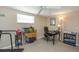 Bedroom features a ceiling fan, a desk, and a view of the backyard through the windows at 3540 Cockatoo Dr, New Port Richey, FL 34652