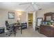 Bedroom boasts neutral walls, ceiling fan, desk, and doorway to another room at 3540 Cockatoo Dr, New Port Richey, FL 34652