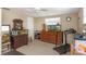 Bedroom features two dressers, two windows, a ceiling fan, and a treadmill at 3540 Cockatoo Dr, New Port Richey, FL 34652