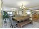 Inviting dining area with a rustic wooden table, bench seating, and a contemporary chandelier, perfect for Gathering gatherings at 3540 Cockatoo Dr, New Port Richey, FL 34652