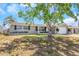 Charming single-story home featuring a well-maintained lawn and beautiful curb appeal with mature landscaping under a sunny sky at 3540 Cockatoo Dr, New Port Richey, FL 34652