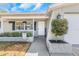Charming front entrance with manicured landscaping, hanging plants, and a welcoming porch at 3540 Cockatoo Dr, New Port Richey, FL 34652