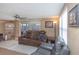 Comfortable living room with a ceiling fan, sliding glass doors, a leather sofa, and tile flooring at 3540 Cockatoo Dr, New Port Richey, FL 34652