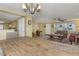 Bright living room with chandelier lighting, tile flooring, and lots of natural light at 3540 Cockatoo Dr, New Port Richey, FL 34652