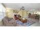 Comfortable living room with tile floors, a ceiling fan, and a cozy seating arrangement centered around a wooden coffee table at 3540 Cockatoo Dr, New Port Richey, FL 34652