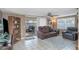 Inviting living room with a sliding glass doors to patio, a ceiling fan, a leather sofa and tile flooring at 3540 Cockatoo Dr, New Port Richey, FL 34652