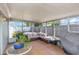 Bright and airy sunroom offers plenty of space to relax and entertain with tile flooring at 3540 Cockatoo Dr, New Port Richey, FL 34652