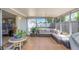 Spacious sunroom with tile flooring, modern furniture, and views of the backyard at 3540 Cockatoo Dr, New Port Richey, FL 34652